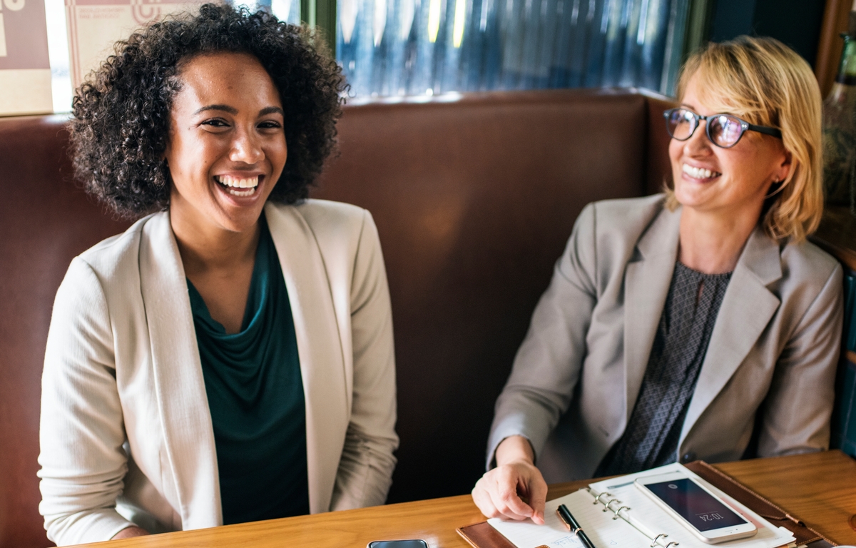 2 women chatting at work and laughing