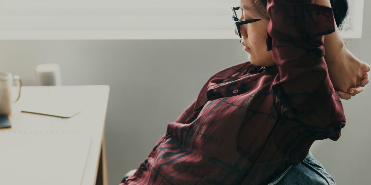 Worker stretching at desk