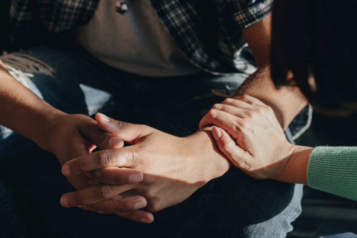 Mental health support, fiend touching friends arm